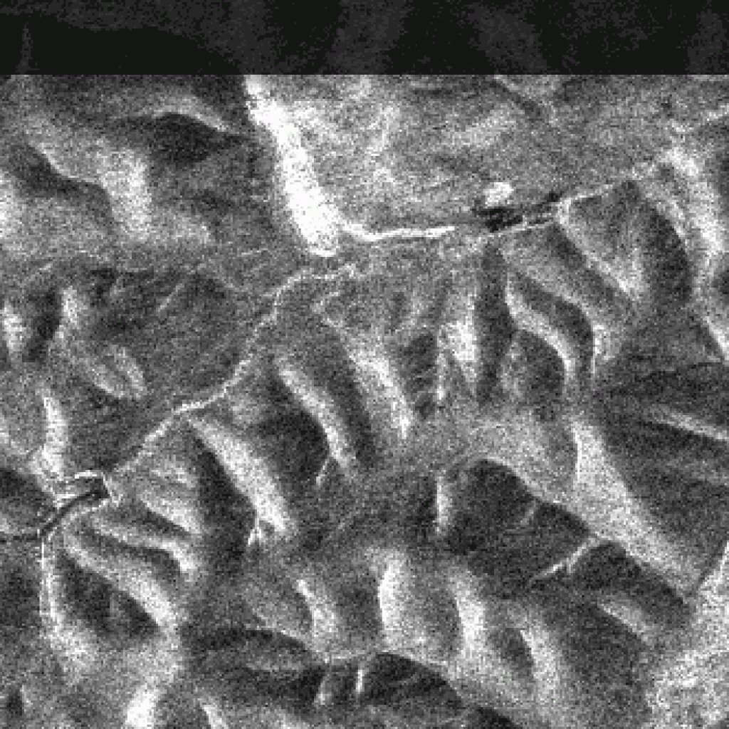 Comparison showing the effect of terrain correction. PALSAR images of hills in Fairbanks, Alaska, before and after terrain correction. The correction involves moving pixels, effectively sliding the hills into the correct geometry. This is a sigma naught image. Actual products are gamma naught. ASF DAAC 2014; Includes Material © JAXA/METI 2008.