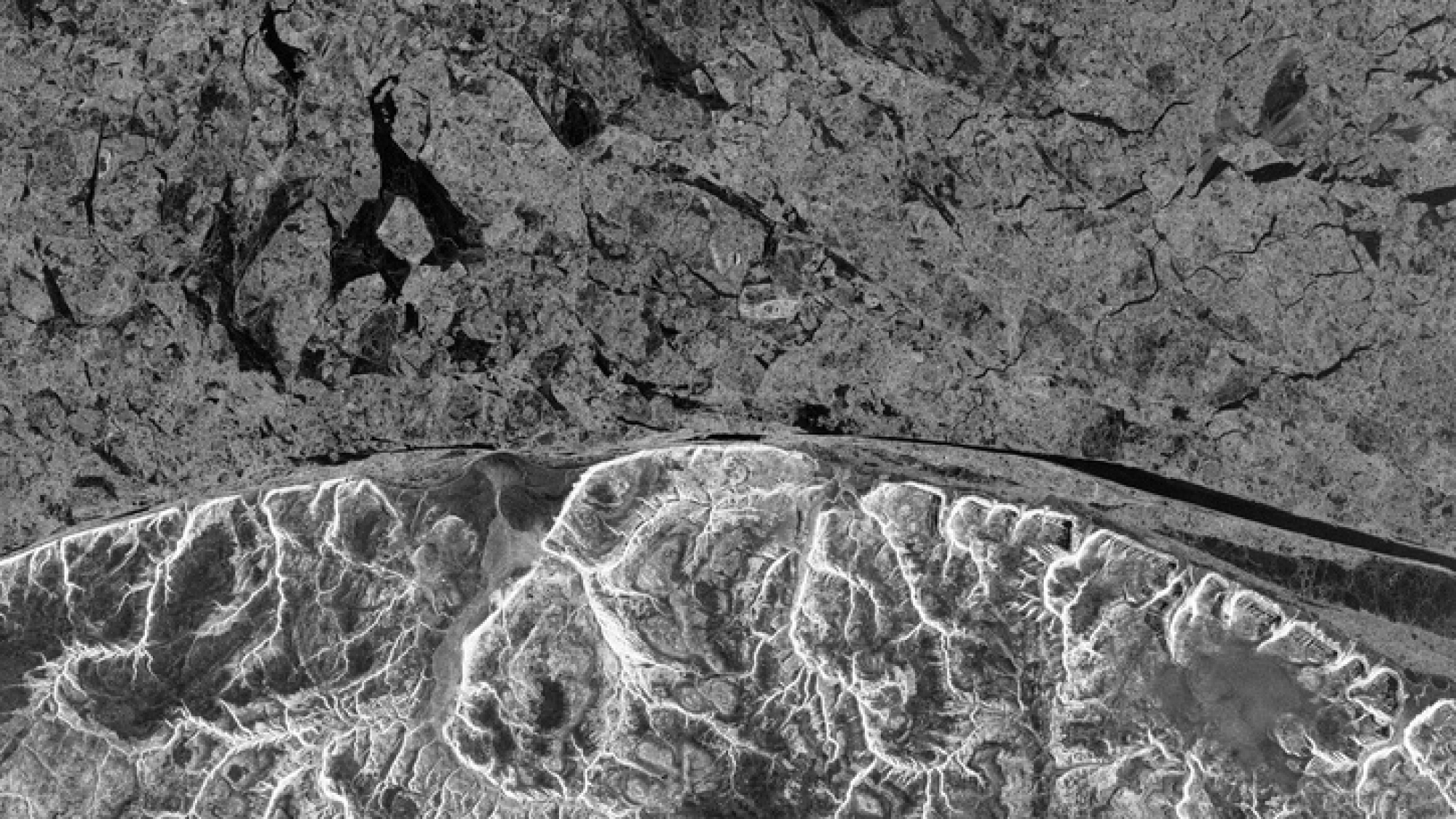 Northwest Passage sea ice contrasts with the coast of Baffin Island, Canada, in this ALOS-PALSAR image taken 8 March 2011. © JAXA, METI 2011